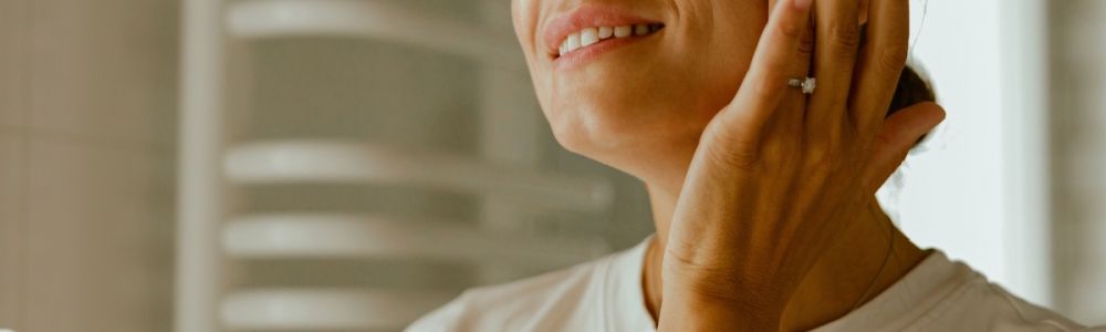 A woman using Houston skincare products