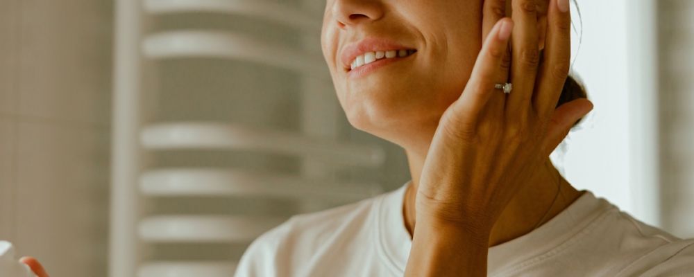 A woman using Houston skincare products